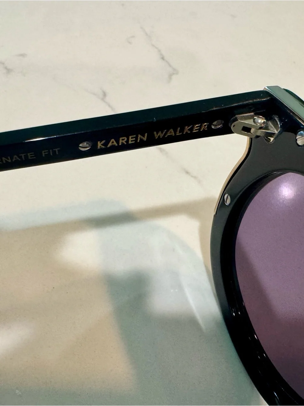 Karen Walker Black Round Sunglasses with Gold Detail and Purple Tint Lenses